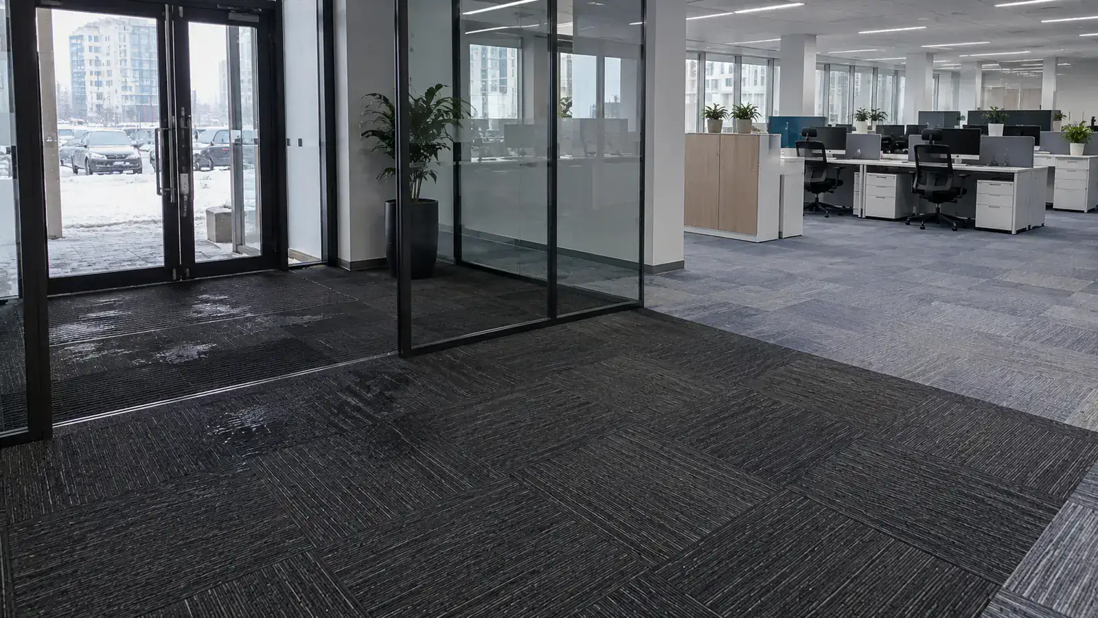 Russian office entrance with dark commercial carpet tiles for winter moisture and lighter modular tiles in workstation area