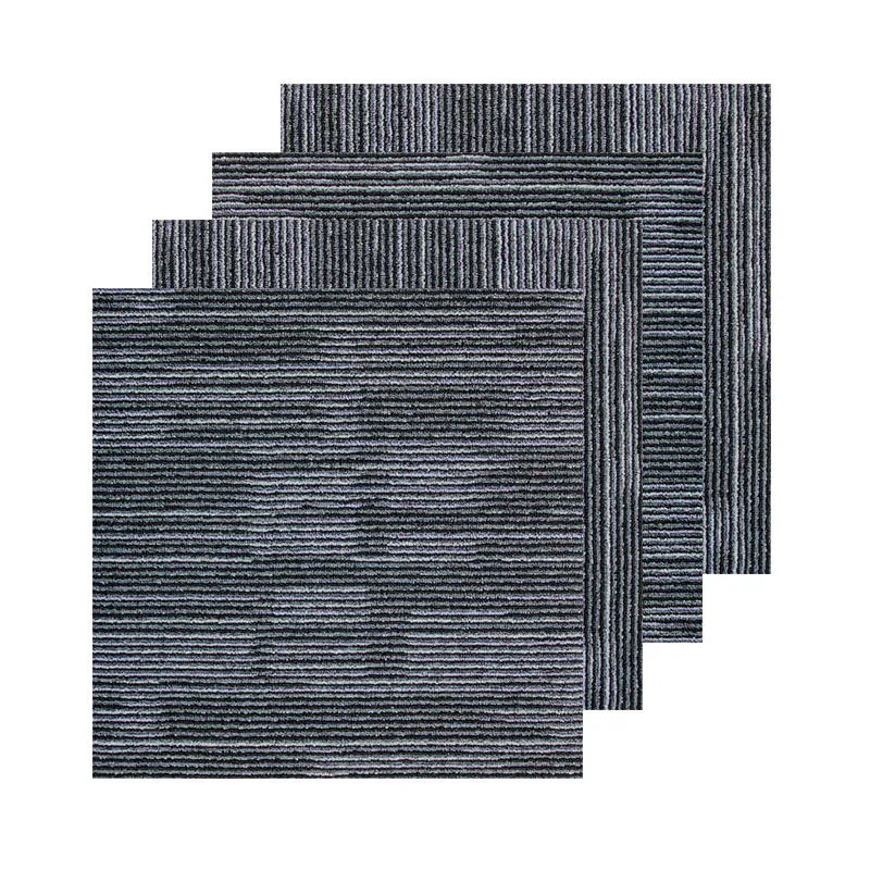 Stacked gray striped carpet tiles with alternating surface directions